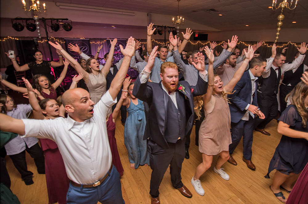 The Boston Wedding Band performs a line dance to a receptive crowd.