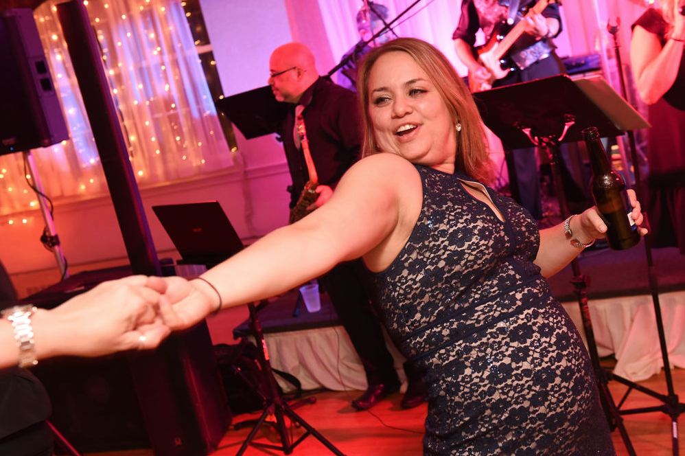 A wedding guest dancing to the music of a Boston Wedding band.
