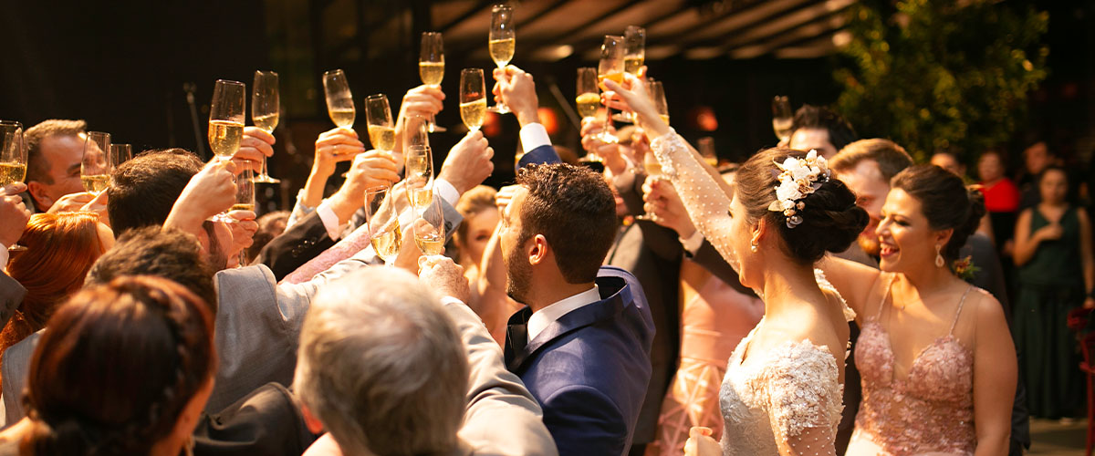 A bridal party raise a toast glass to the bride and groom at a wedding in Boston
