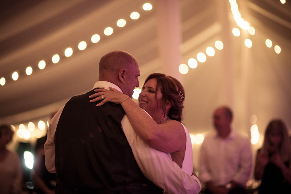 The Bride and Groom slow dancing under the tent lights.