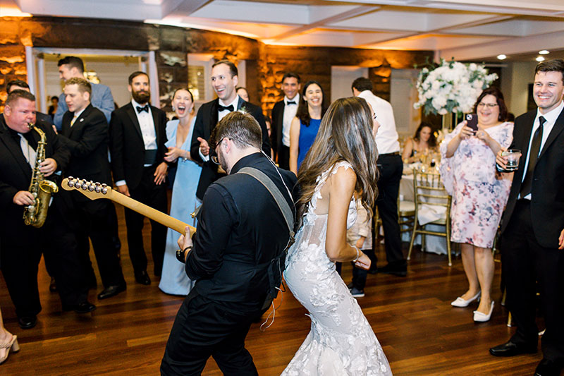 The Bride dancing with the guitarist of the band on the dance floor.