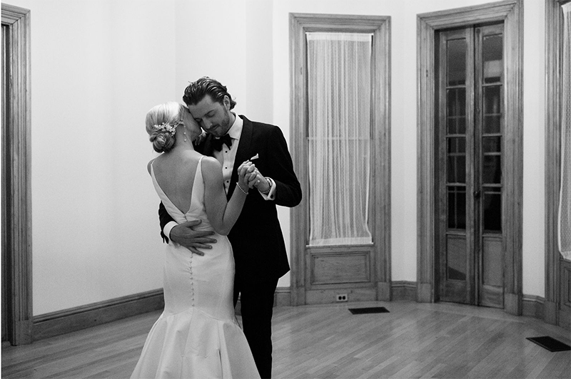 The bride and groom share a private dance together alone inside the mansion