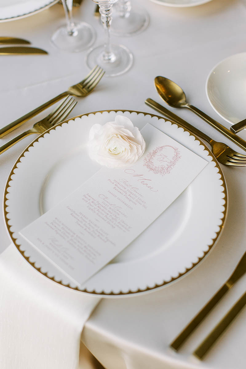 A beautiful wedding place setting at one of the tables in the ball room.