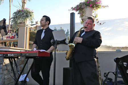 Boston Premier's keyboiardist and saxophonist performing at a wedding cocktail hour.