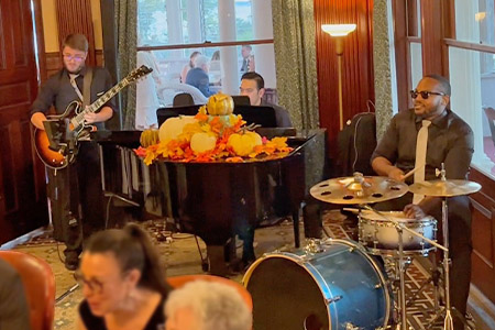Boston Premier's jazz trio performs a cocktail hour as guests mingle in East Providence, Rhode Island.