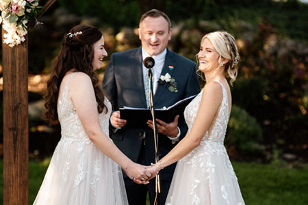 Two beautiful brides exchanging vows at their wedding ceremony held in Topsfield, Massachusetts.