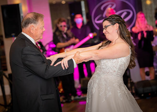 A bride dancing with her father at her wedding.