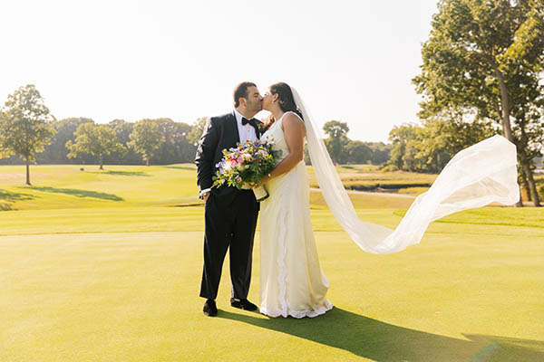 Carly and Zach posing for a formal wedding photo