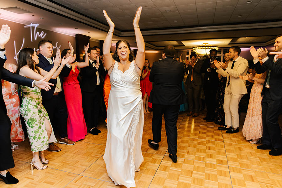 The Bride dancing and smiling as Boston Premier performs one of her favorite songs.