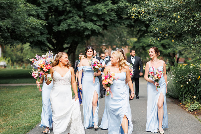 Bridesmaids walking in the path at the Garden at Elm Bank