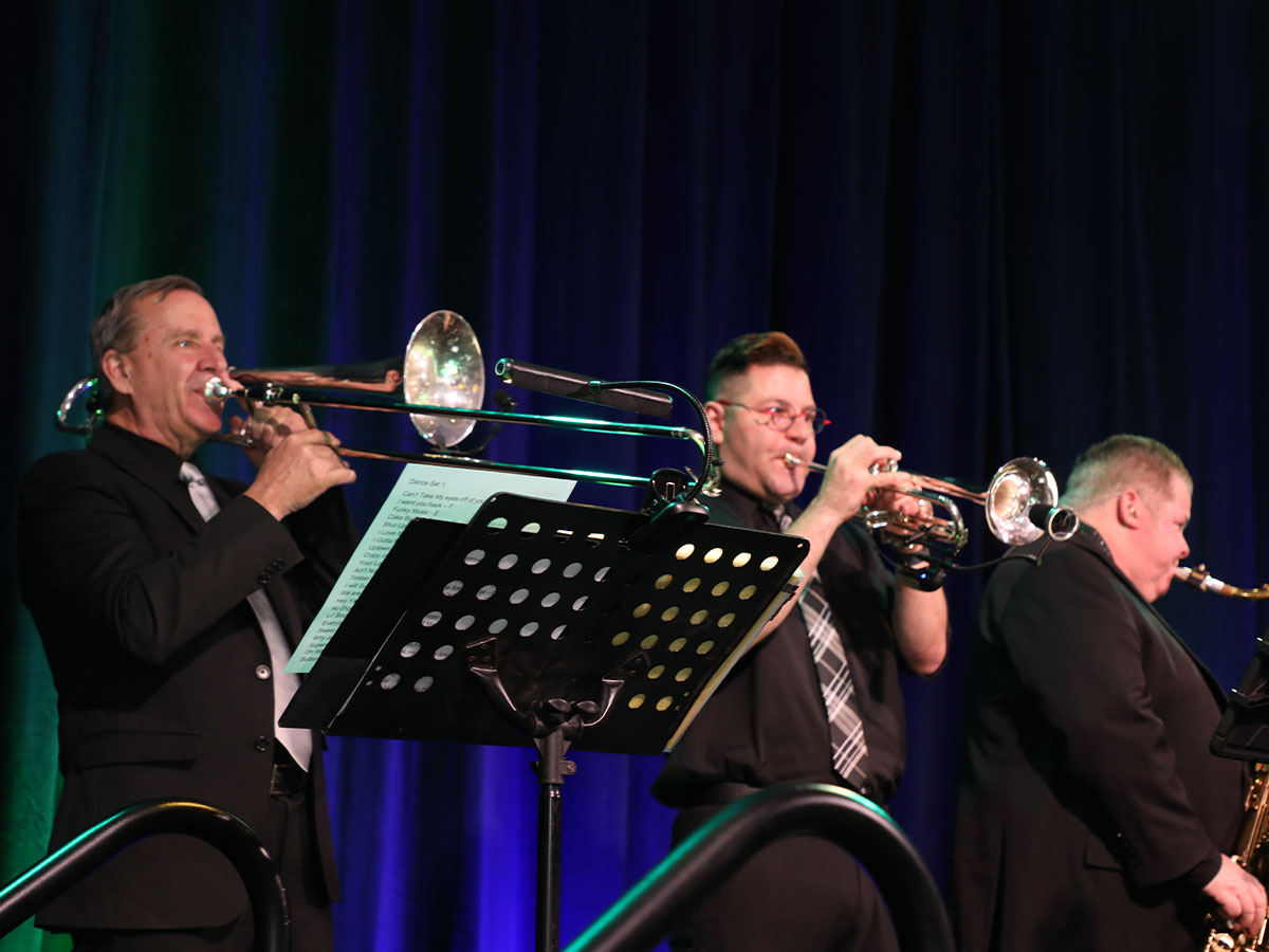 BP Horn Section playing on stage.