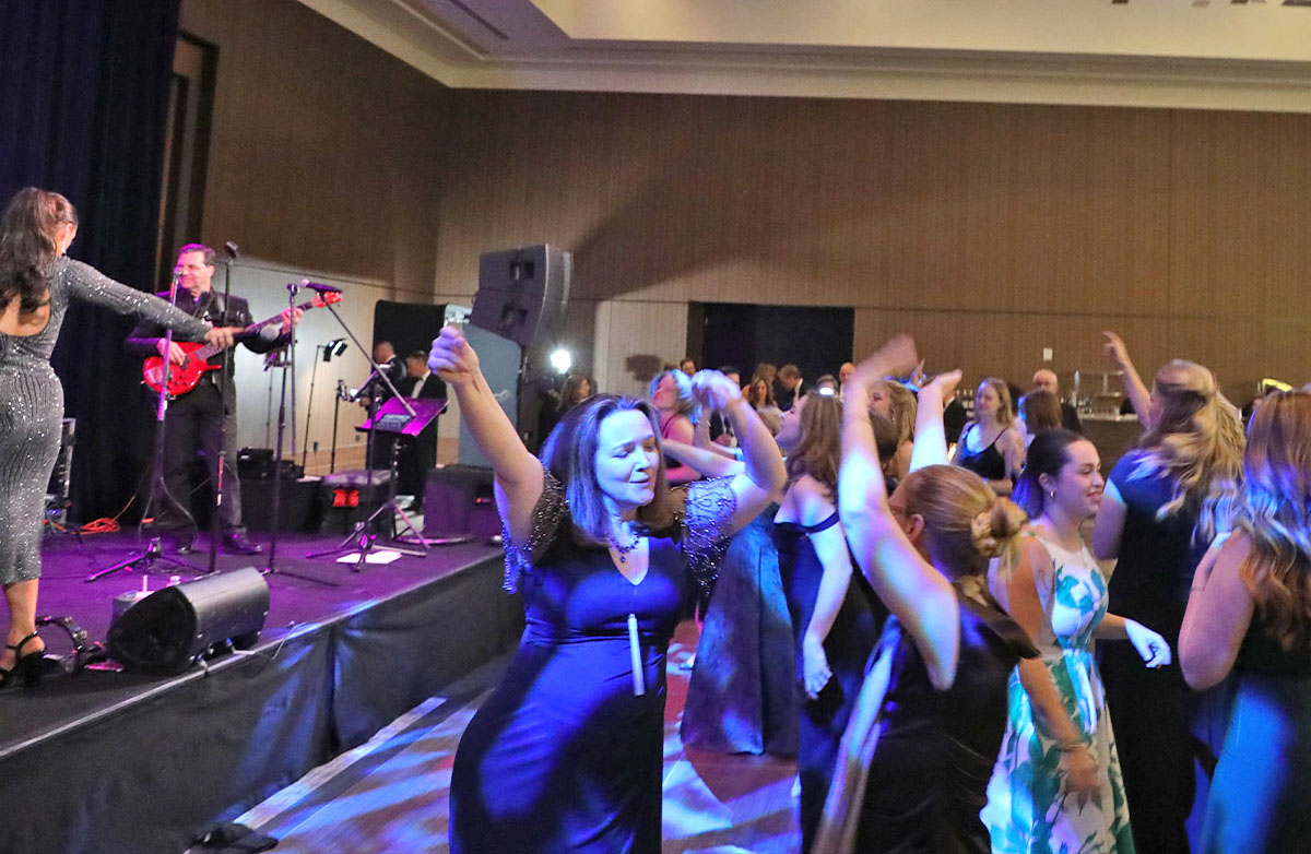 T1D Gala with a full dance floor and Boston Premier on stage.