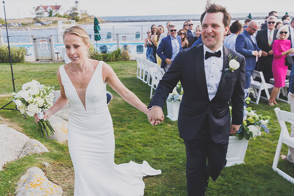 A bride and groom celebrating their wedding at Eastern Point Yacht Club in Gloucester, Massachusetts