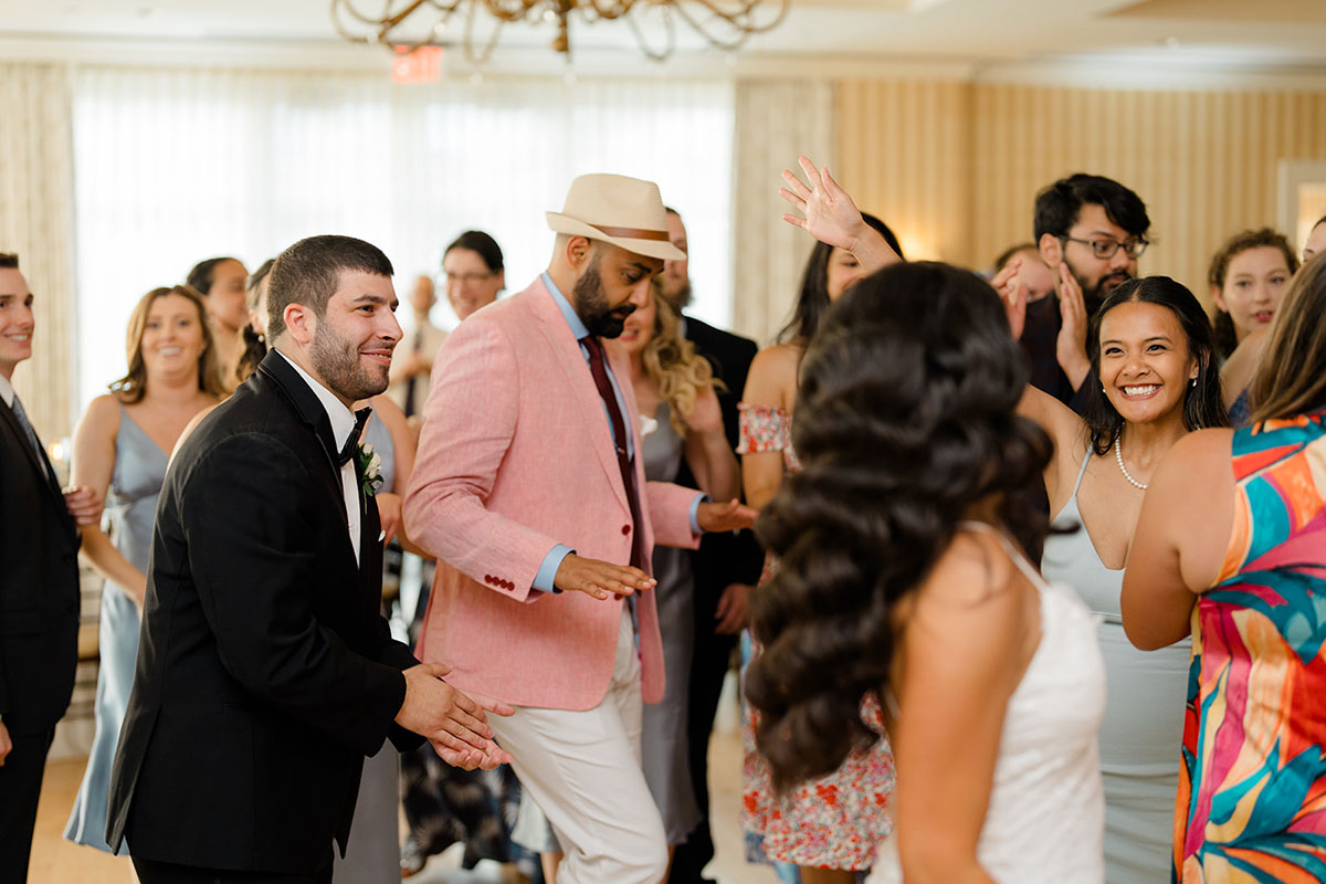 The crowd floods the dance floor as Boston Premier plays music.